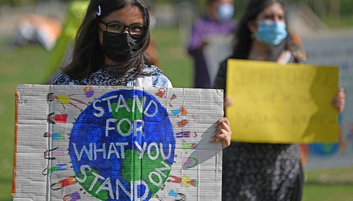 Climate activists hold placards as they take part in a demonstration in support of the environmental and climate protection movement ‘Fridays for Future’ in Islamabad on March 19, 2021. — AFP