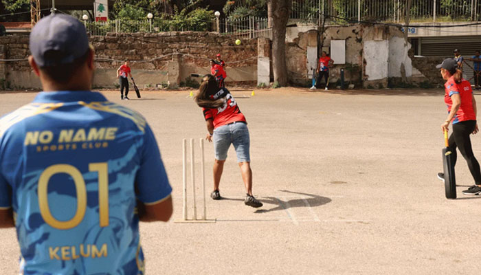 Members of a foreign womens cricket team play compete during a match held at a parking lot in Beirut on May 19, 2024. — AFP