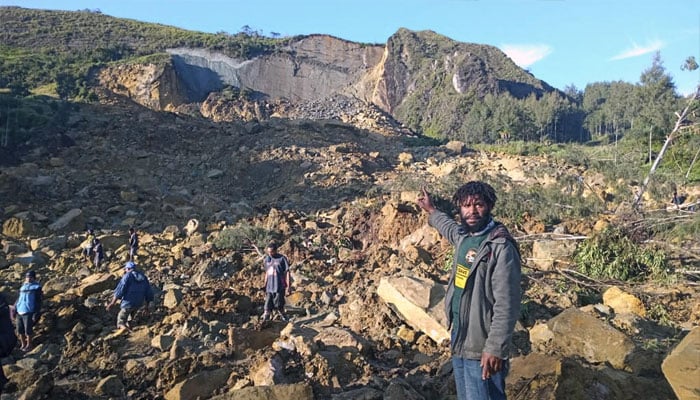 People seen at the location of a land slide in Papua New Guineas Enga province. — AFP/file