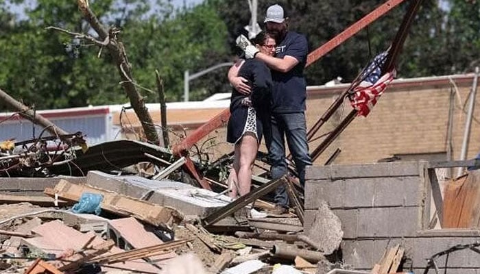 Phillip and Kimberly Ergish embrace as they look at the remnants of their home the day after a deadly tornado struck Greenfield, Iowa, US May 22, 2024. — Reuters
