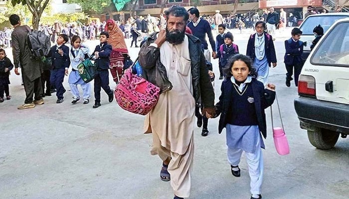 A representational image showing parents accompanying their children on the way to school. — APP/File