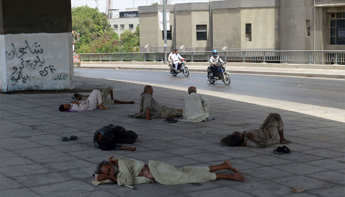 Men rest under a bridge during a heatwave in Karachi on June 29, 2015.– AFP