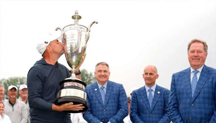 Richard Bland of England celebrates with the Alfred S. Bourne Trophy after winning the KitchenAid Senior PGA Championship at Harbor Shores Resort on May 26, 2024 in Benton Harbor, Michigan. — AFP/file