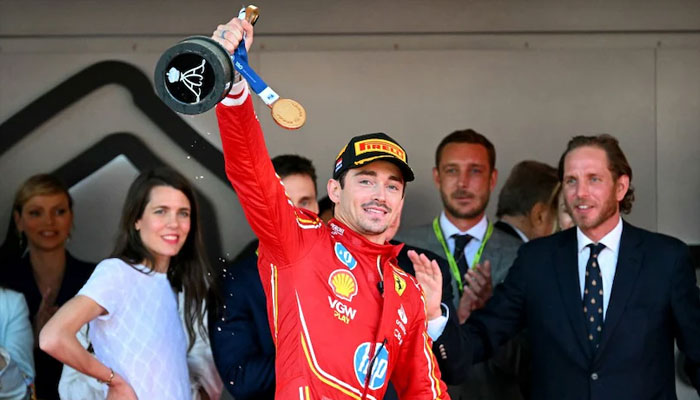 Charles Leclerc celebrates on the podium after the Formula One Monaco Grand Prix on May 26, 2024.—AFP