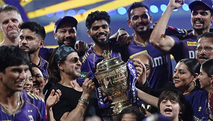 KKR owner Shah Rukh Khan poses the trophy along with his family and KKR players after the IPL final on May 26, 2024. — AFP