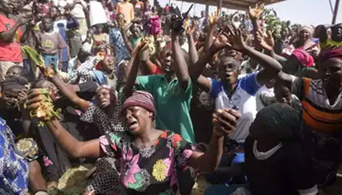 Victims of a gunmen attack react at the internal displaced camp.— PTI/file