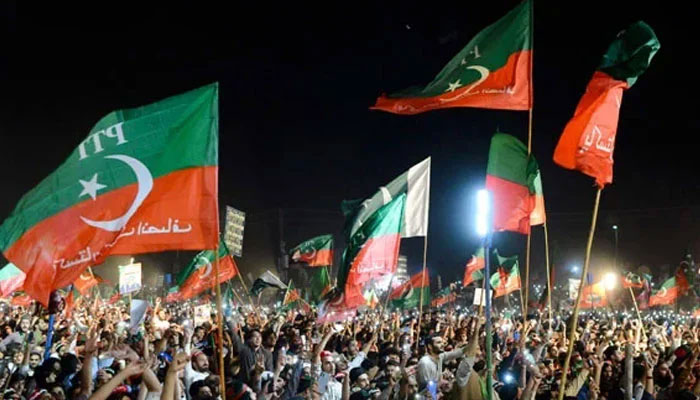 PTI workers at an election rally. — AFP/File