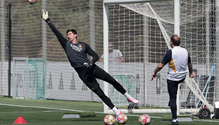 Real Madrid goalkeeper Thibaut Courtois seen jumping in this photo.— AFP/file