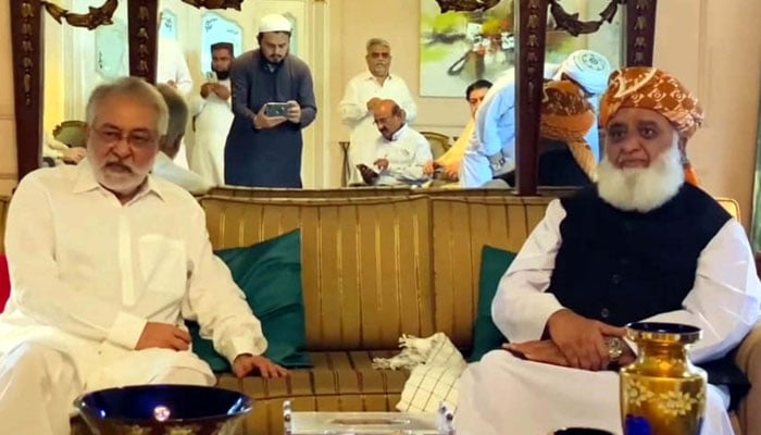 Grand Democratic Alliance (GDA) Chief, Pir Sibghatullah Shah Rashidi (L) exchanges views with Maulana Fazal-ur-Rehman, Chief of Jamiat Ulema-e-Islam (JUI-F) (R) during a meeting in Karachi on May 28, 2024. — PPI