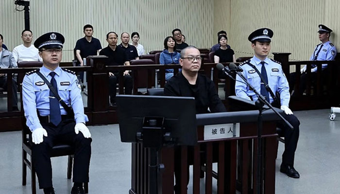 This photo released by the Tianjin No.2 Intermediate People’s Court shows Huarong Asset Managements subsidiarys former general manager Bai Tianhui (C) during his sentencing at the court on May 28, 2024. — AFP