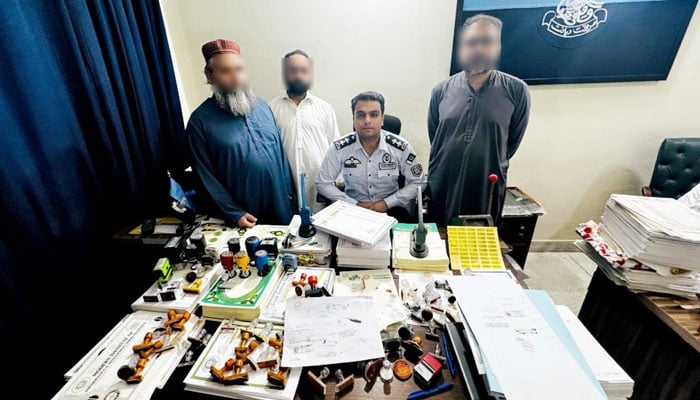 An FIA official pictured with arrested owners of institutions issuing fake and unregistered degrees on May 29, 2024. — Facebook/Federal Investigation Agency - FIA