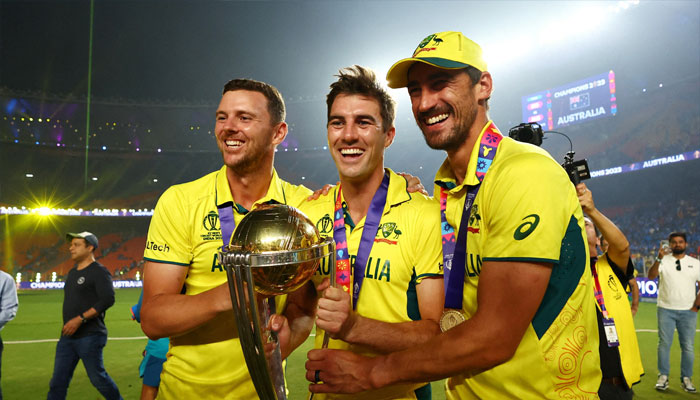 Australias Josh Hazlewood, Pat Cummins and Mitchell Starc celebrate with the trophy after winning the ICC Cricket World Cup. — Reuters/file