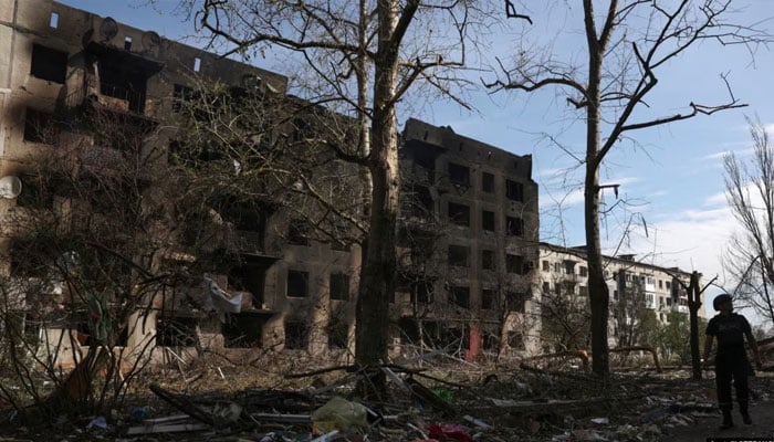 A man passes by houses destroyed by artillery fire and air raids in the village of Ocheretyne in the Donetsk region. — AFP/File