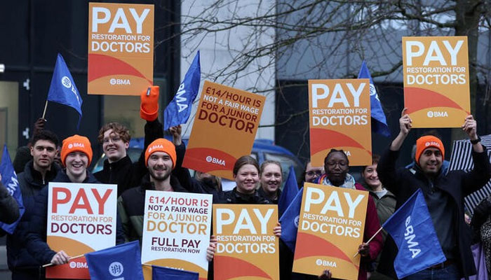 Junior doctors hold placards as they stand on a picket line outside the Royal University Hospital during a national strike over pay and conditions, in Liverpool, Britain, January 3, 2024. — Reuters