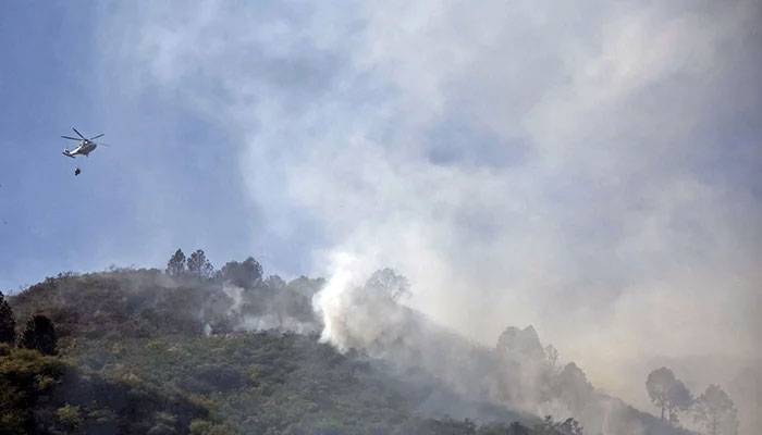 Helicopter douses flames on the Margalla Hills in Islamabad, May 28, 2024. — Online