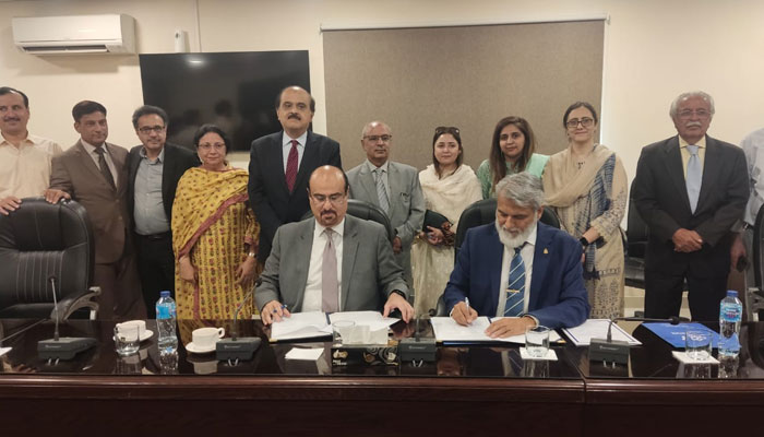 Officials of the (IMDC) and (FDE), sign a Letter of Understanding (LoU) in this image. — Radio Pakistan/File