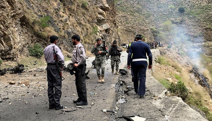 Security personnel inspect the site of the attack near Besham in the Shangla district of Khyber Pakhtunkhwa province. — AFP/file