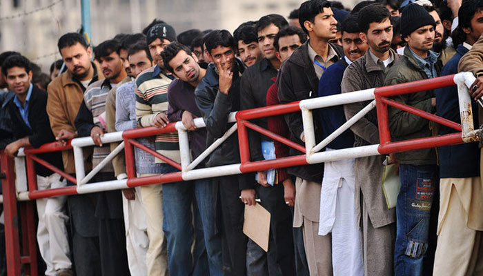 Pakistani youth wait for their turn for a Capital Development Authority (CDA) job entry test in Islamabad. — AFP/File