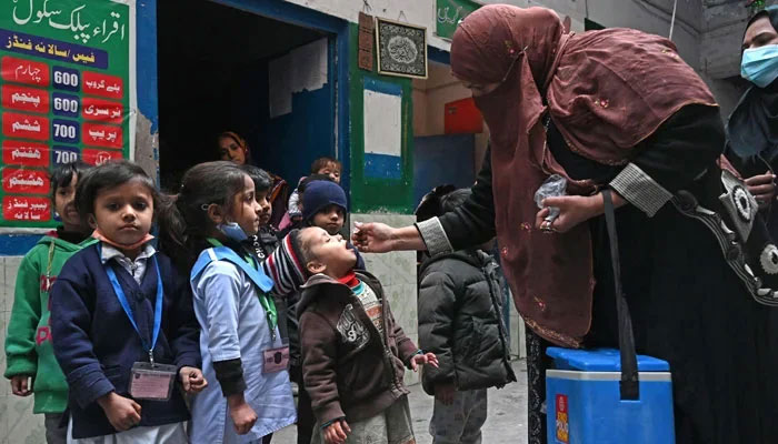 A health worker administers polio vaccine to children. — AFP/File