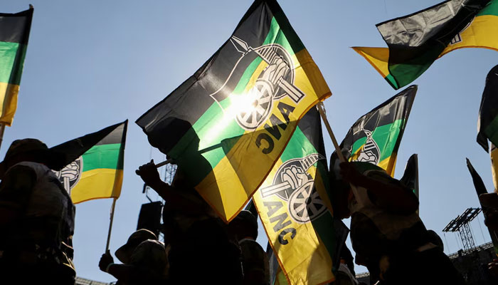 Supporters of the African National Congress (ANC) wave party flags during their final rally ahead of the upcoming election at FNB stadium in Johannesburg, South Africa, May 25, 2024. — Reuters