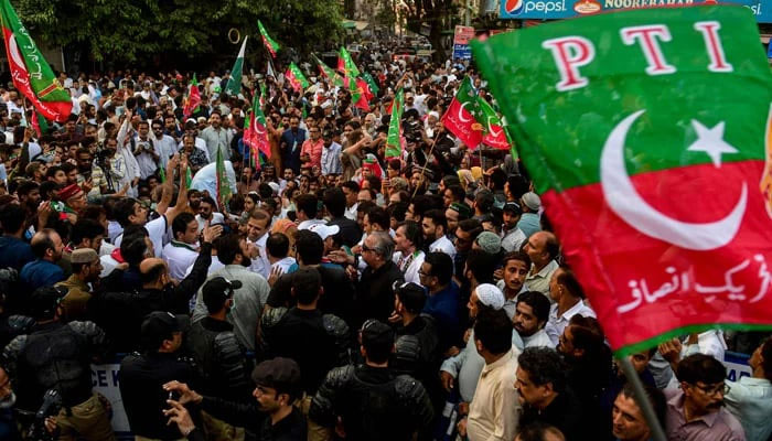 A representational image showing PTI workers and supporters holding a demonstration on a street in Karachi. — AFP/File