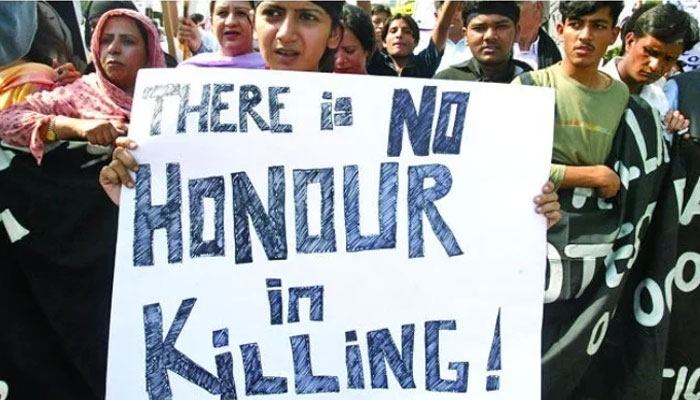 A representational image showing a woman holding a banner against honour killing at a protest in Pakistan. — Reuters/ file