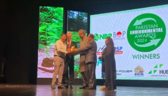 Former prime minister Shahid Khqan Abbasi and Ambassador of Belgium Charles Delogne present an award for awareness of the Environment and Education at PNCA on June 4, 2024. — Screengrab via Facebook/Jamshaid Sultan