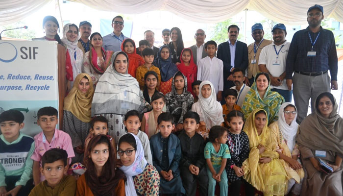 Participants pose for a group photo at an event. — APP/File