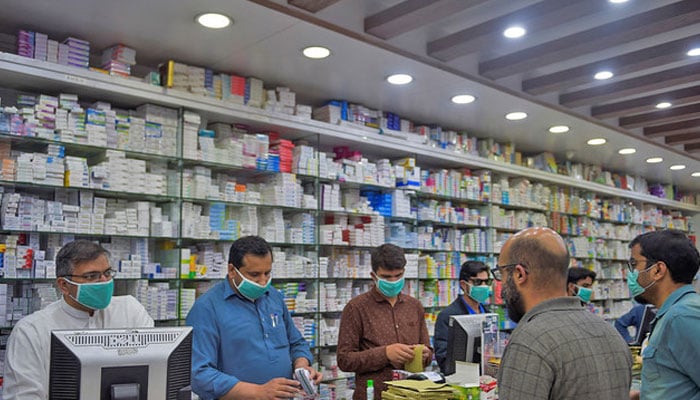 Pharmacy employees attend to customers in Islamabad in this undated image. — AFP/File