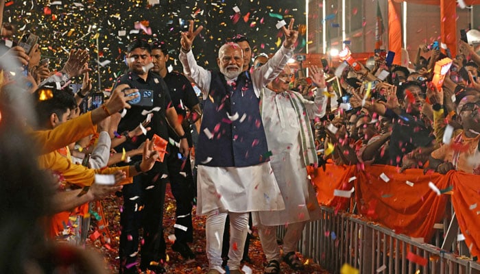 Indian PM Narendra Modi flashes a victory sign as he arrives at the Bharatiya Janata Party (BJP) headquarters to celebrate the partys win in the country´s general election, in New Delhi on June 4, 2024. — AFP