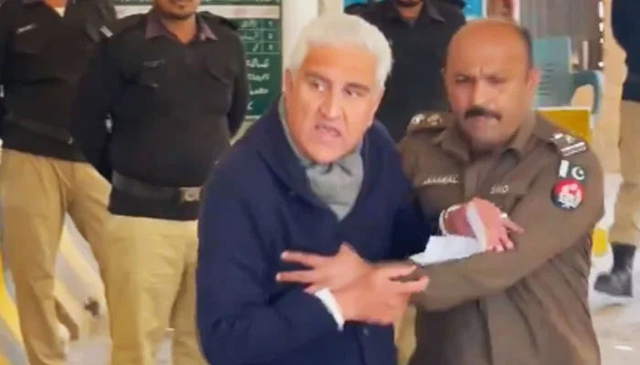 PTI leader Shah Mahmood Qureshi being escorted by a police officer in Rawalpindi, on August 21, 2023.— Screengrab via Geo News