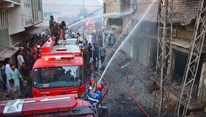 Firefighters struggle to extinguish the fire at an LPG gas shop after cylinder explosion in Hyderabads Paretabad area on May 30, 2024. — APP