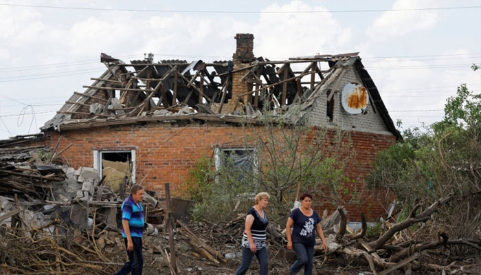 Local residents walk past a house damaged by recent shelling in the course of Russia-Ukraine conflict the village of Rozivka (Rozovka) in the Donetsk region, Russian-controlled Ukraine, June 3, 2024. — Reuters