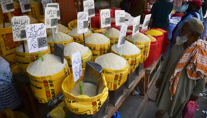 A man looks at rice prices at a market in Karachi on February 3, 2023. — AFP