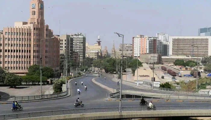 Commuters make their way through a partially deserted bridge in Karachi. — AFP/File