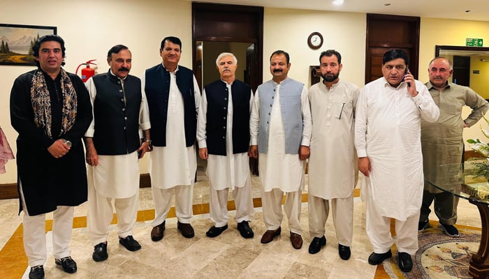 This image released on June 8, 2024, shows PMLN provincial President Amir Muqam (3rd-R), who is Federal Minister for Kashmir Affairs, and PTIP Chairman Mahmood Khan (C) in Islamabad. — Facebook/Amir Muqam