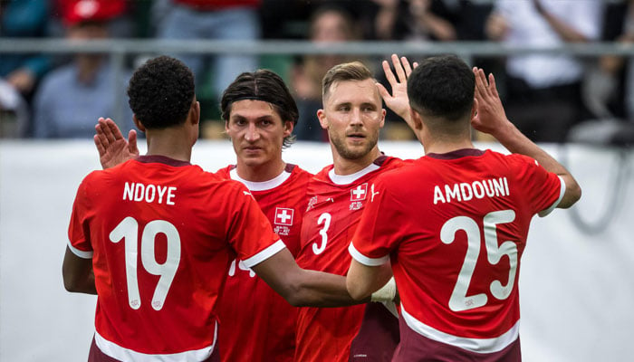 Switzerlands Silvan Widmer (2nd R) celebrating after scoring a goal. — AFP/file