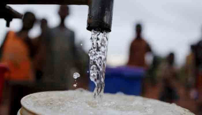 The representational image shows people waiting for their turn to fill their cans with water. — APP File