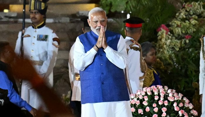 Indias newly sworn-in Prime Minister Narendra Modi gestures to the gathering during the oath-taking ceremony at the presidential palace Rashtrapati Bhavan in New Delhi on June 9, 2024. — AFP