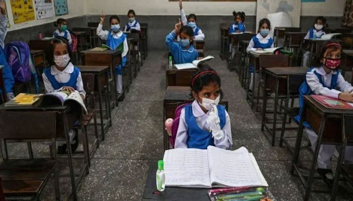 This image shows school students sitting in a class. — AFP/File