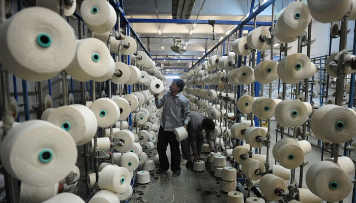 In this image, a man can be seen working in a textile factory in Pakistan. — AFP/File