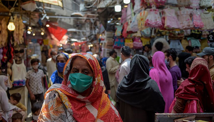A representational image showing people shopping at a crowded market in Rawalpindi.— AFP/File