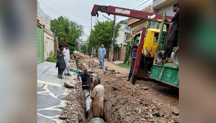 In this image labourer laying a sewerage line. — Facebook/Peshawar Development Authority/File