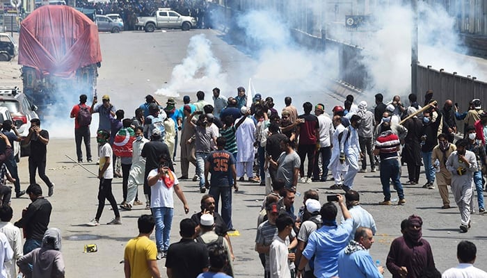 Police use tear gas to disperse activists of the PTI, the party of ousted prime minister Imran Khan, during a protest in Lahore on May 25, 2022. — AFP