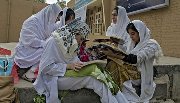 Psychology students study outside the Competence and Trauma Centre for Journalists inside a universitys psychology department in Peshawar on November 24, 2014. — Reuters