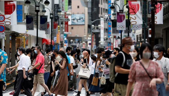 People walk at a crossing in Shibuya shopping area in Tokyo, Japan on August 7, 2021. — Reuters