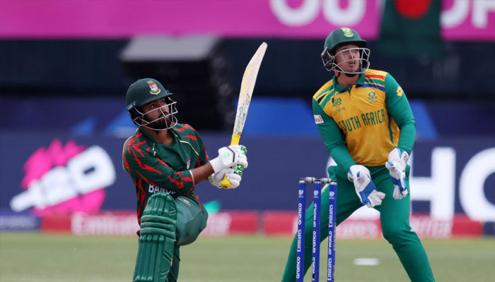 Towhid Hridoy of Bangladesh plays a shot while Quinton de Kock looks on. — AFP/file