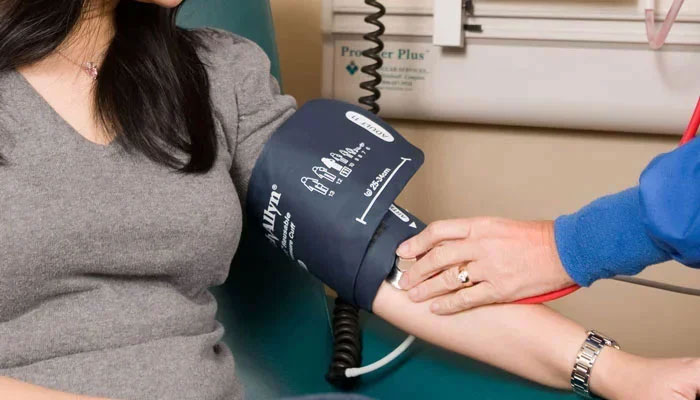 This representational image shows a healthcare worker checking the blood pressure of a patient. — Unsplash/File