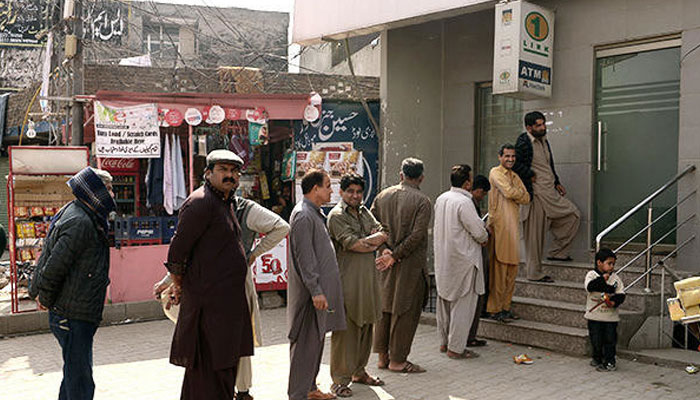 People standing outside the bank.—AFP/File