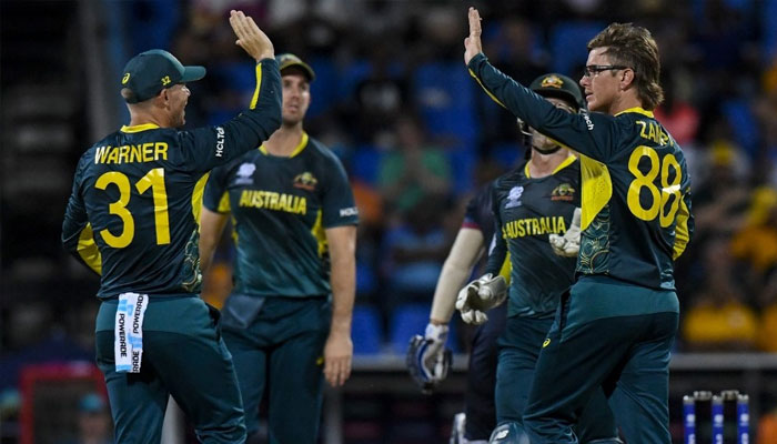 Australias Adam Zampa (R) celebrates the dismissal of Namibias Zane Green during the ICC mens Twenty20 World Cup 2024 group B cricket match between Australia and Namibia at Sir Vivian Richards Stadium in North Sound, Antigua and Barbuda on June 11, 2024. — AFP